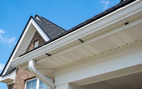Crisp white vinyl soffit and fascia on a residential roofline.